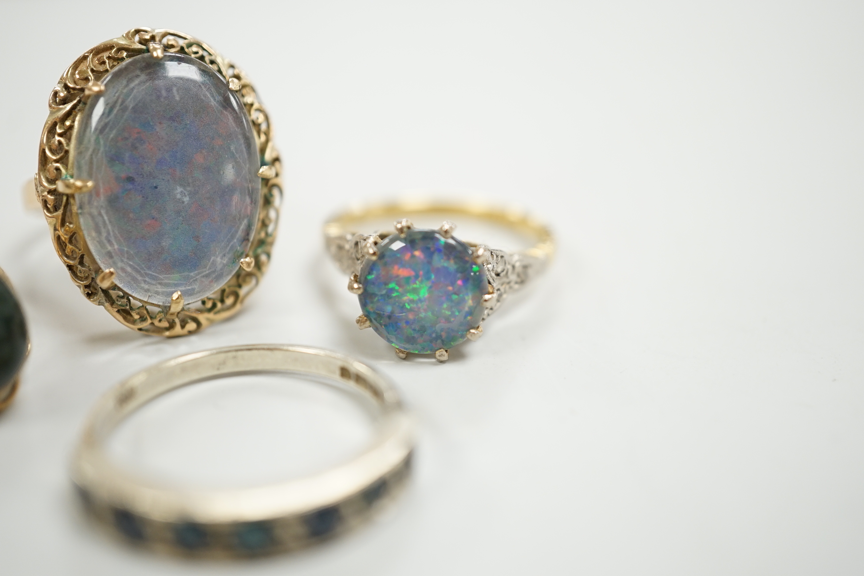 A 1940's 18ct and black opal doublet set dress ring, with diamond chip set shoulders, size L, a 14c and oval doublet ring and two other 9ct and gem set rings.